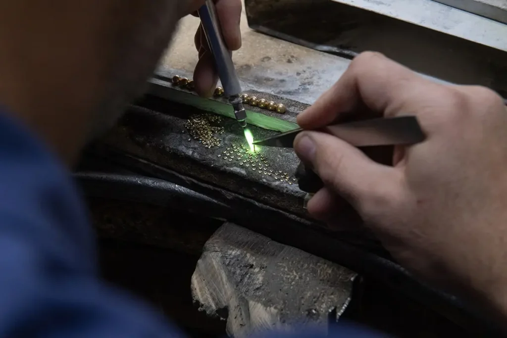 manual process of soldering gold components for jewelry